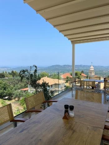 Breathtaking sunset view from the cliffside terrace of Vrahos Taverna