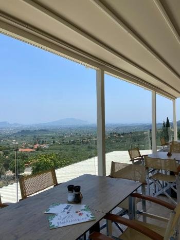 Breathtaking sunset view from the cliffside terrace of Vrahos Taverna