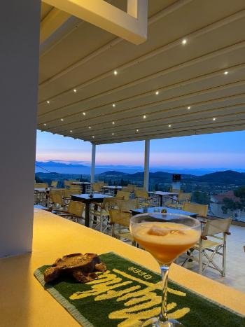 Breathtaking sunset view from the cliffside terrace of Vrahos Taverna